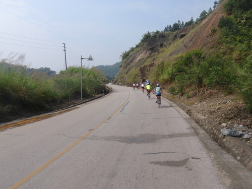 A part of the cycling group, heading up hill.